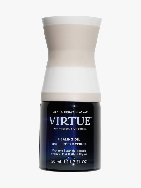 Virtue Healing Oil squat navy bottle with white and beige hourglass shaped cap on light gray background